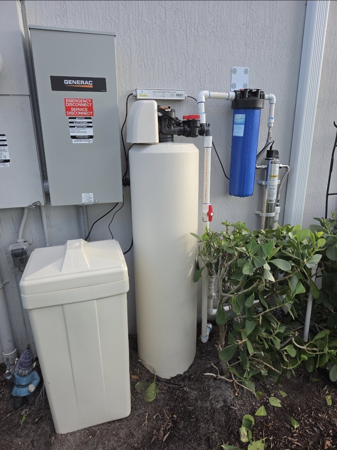 Installed whole-home filter with stainless-steel ultraviolet disinfection chamber and Big Blue prefilter
